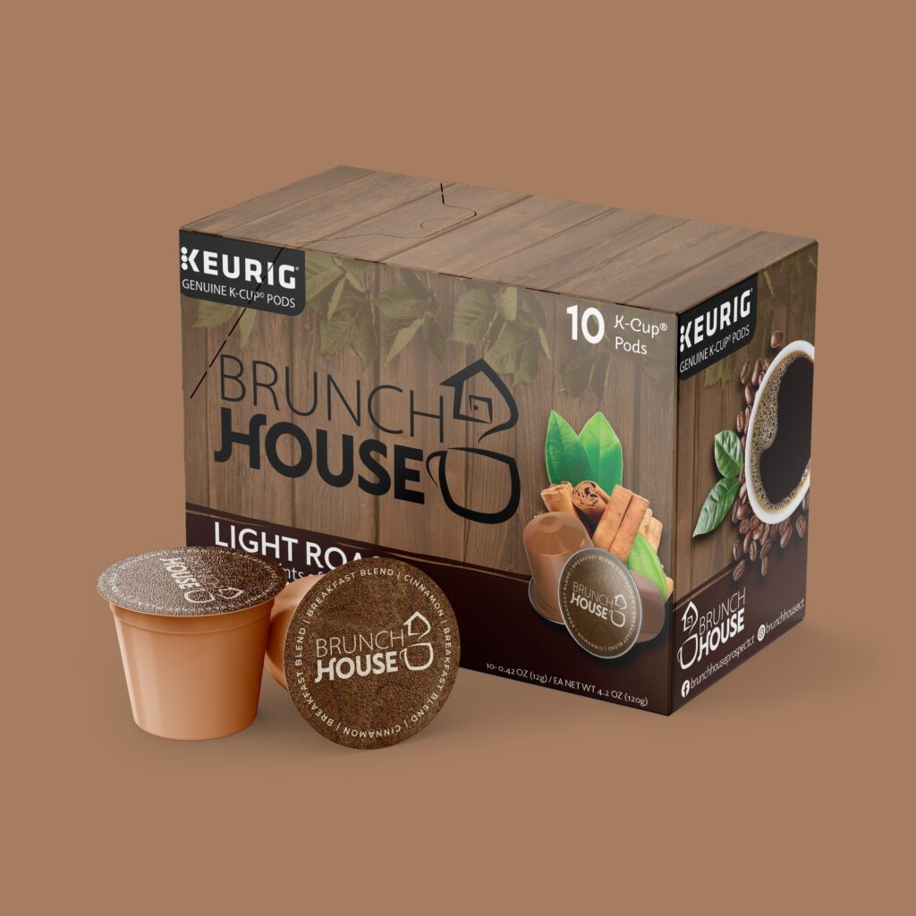 A Keurig coffee box with 2 small cups next to it. The box has a wooden pattern.